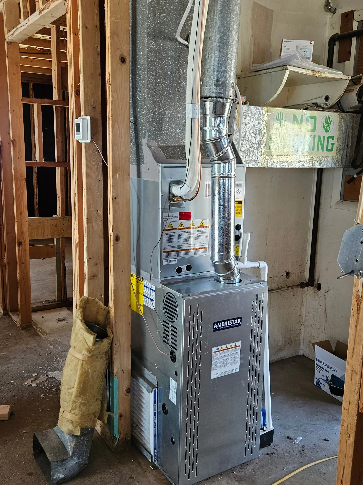 New Ameristar furnace with metal ductwork and venting installed in residential basement
